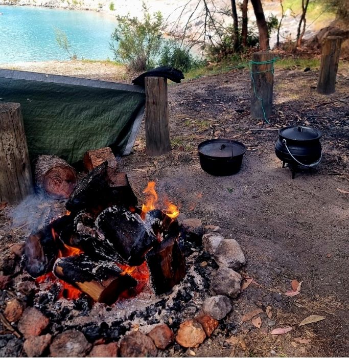 supporting picture showing the preparation for camp cooking. The paragraph is on food and essentials