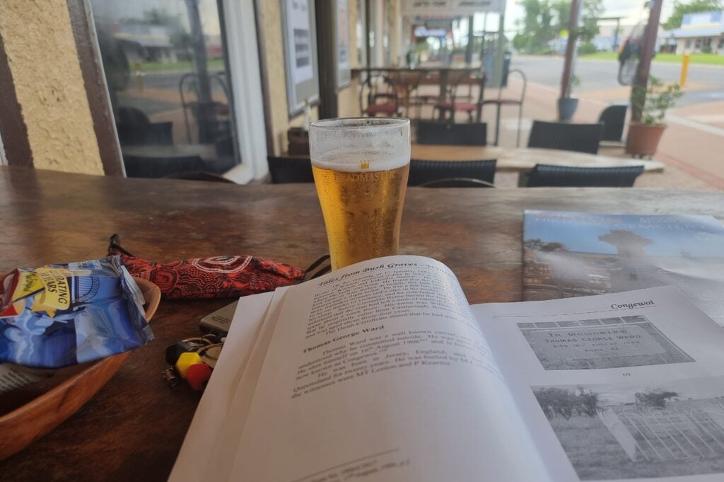 Showing the solo female traveller reading a book at the pub